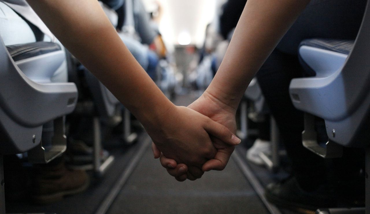 Couple planning their first day’s itinerary together during a long-haul flight.