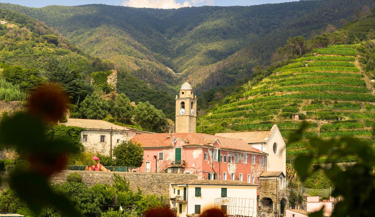 Hilltop village with stone buildings overlooking a lavender-filled valley