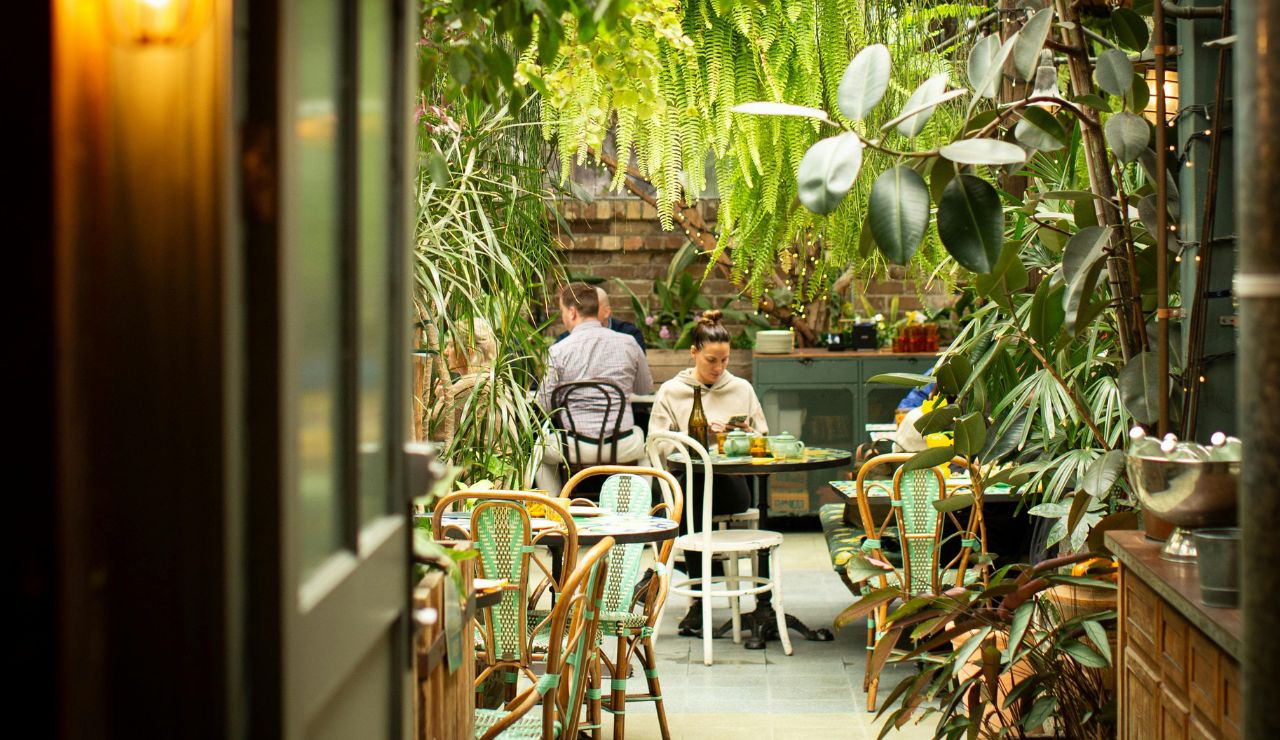 Lush garden café at The Grounds of Alexandria with floral decor.
