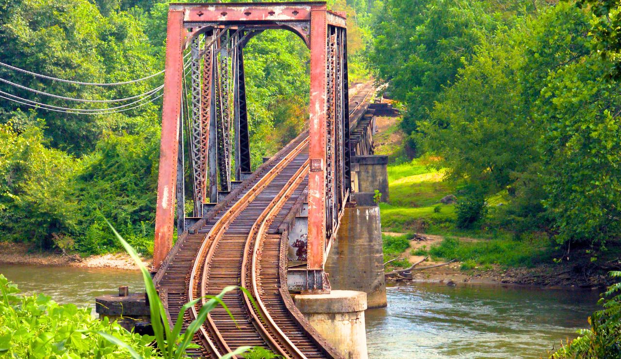 Cyclists crossing a wooden trestle bridge on the Kettle Valley Rail Trail