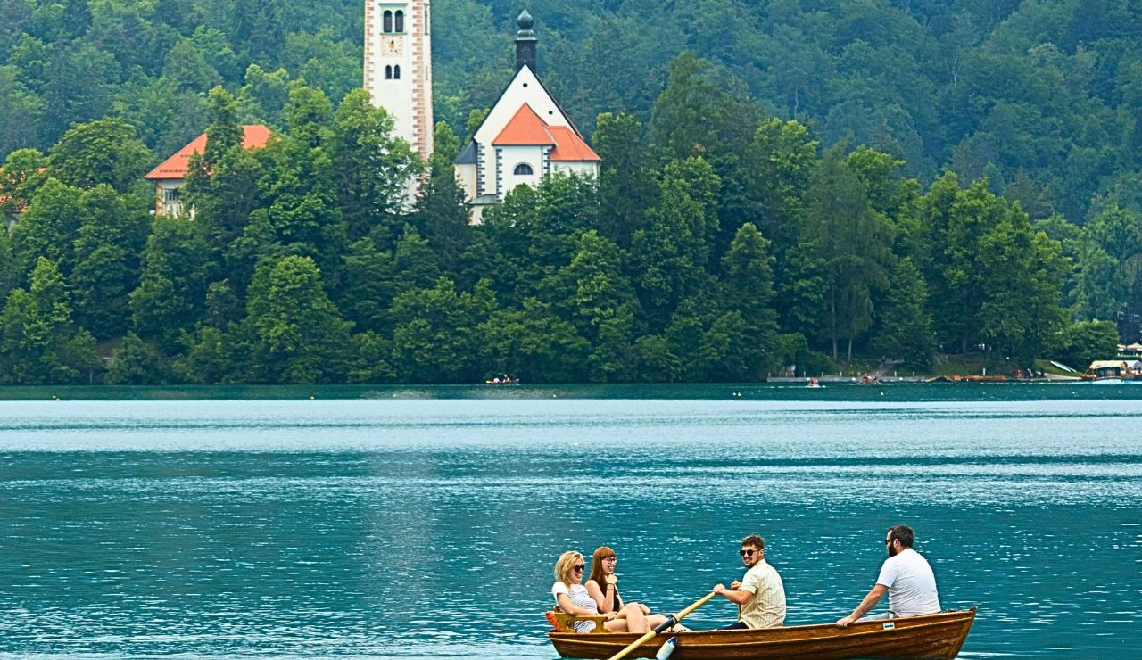 Couple in a rowboat on Lake Bled heading to the island church.