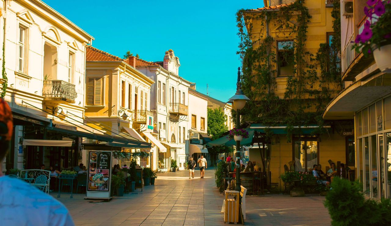 Shaded street lined with boutiques and cafés in a sunny Provençal village