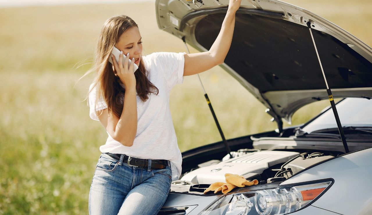 Mechanic inspecting car engine before summer road trip