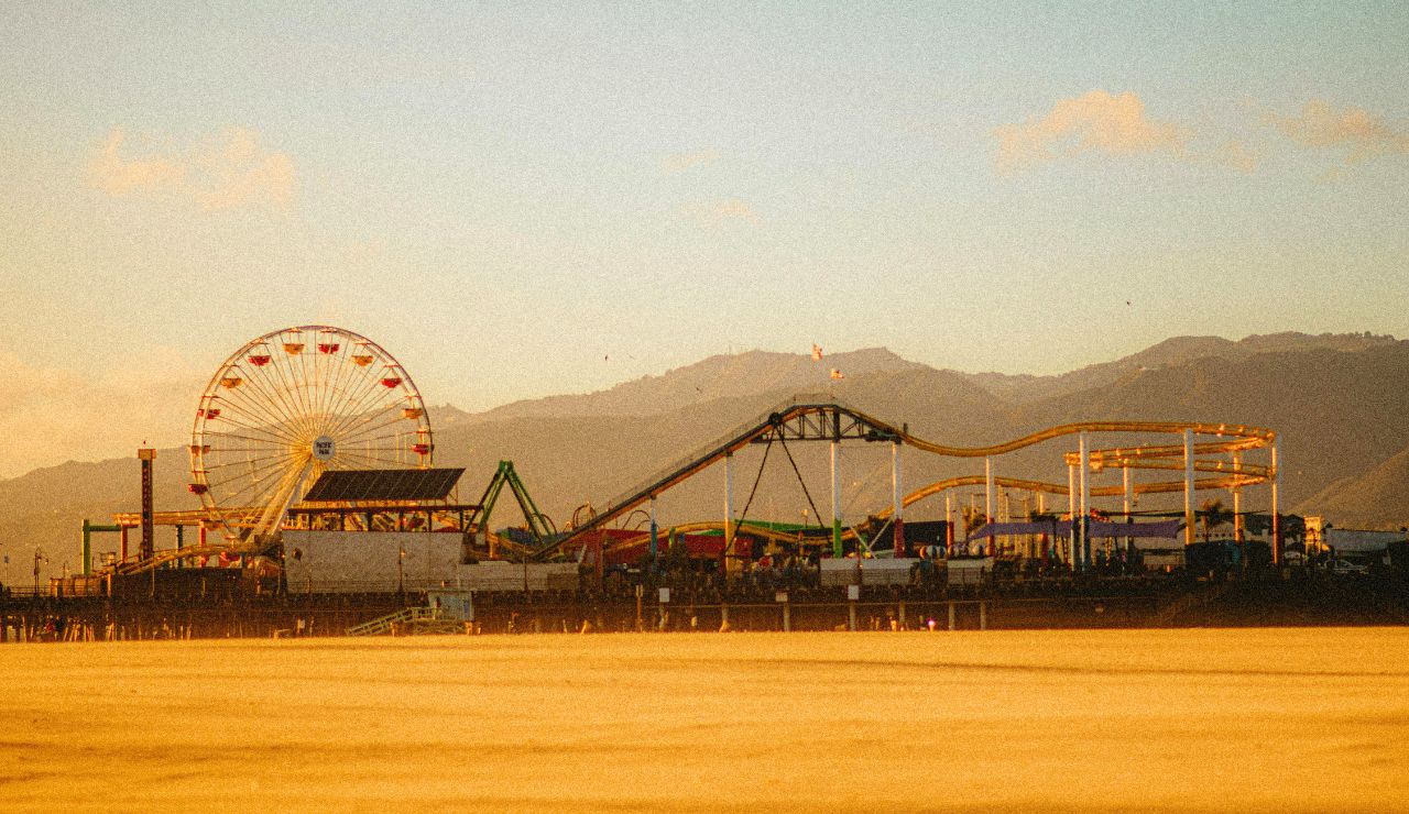 Pier and surfers at sunset in Pismo Beach, California