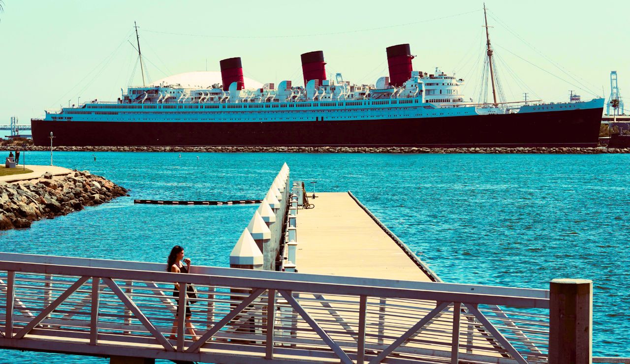 Docked Queen Mary cruise ship under dramatic sky in Long Beach, California