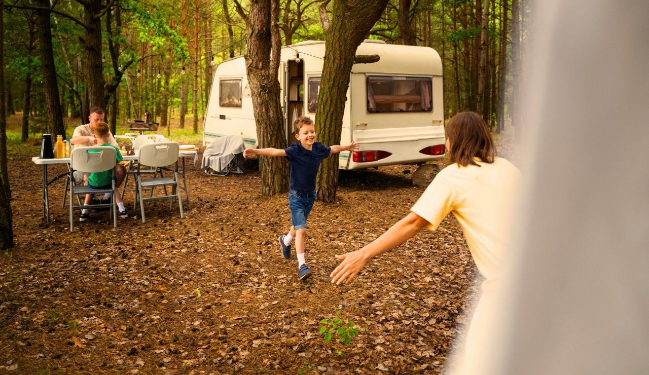 Reserved campsite sign with RVs in the background at a wooded park