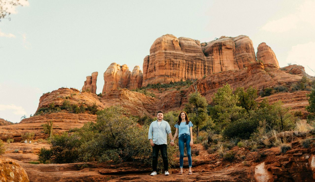 Couple watching the sunset over Sedonaās red rock canyons.