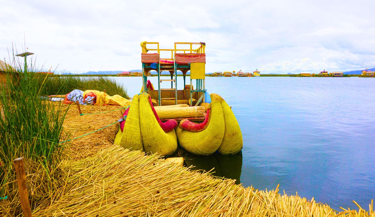 Reed huts and handmade boats on the floating Uros Islands in Peru