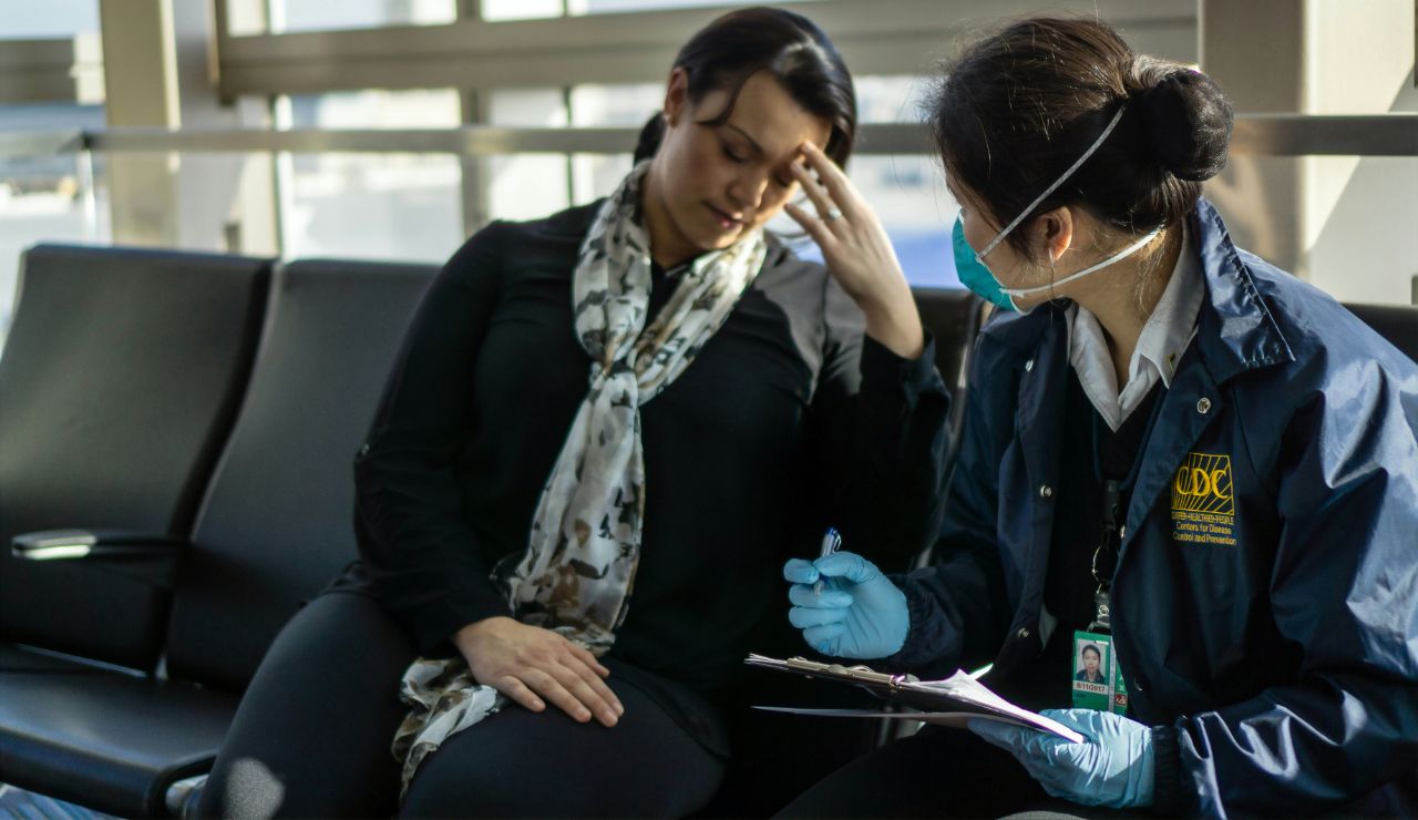  Customs officer reviewing pet paperwork at an airport counter.