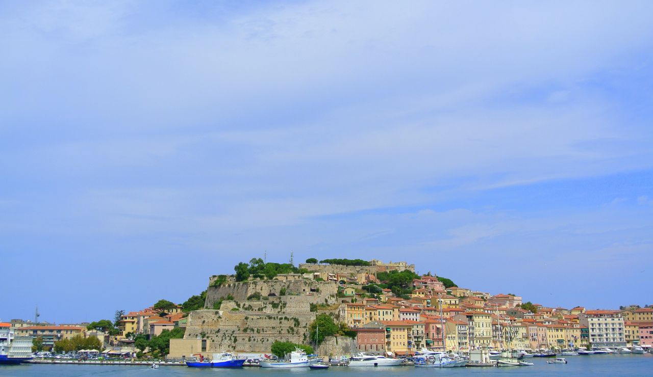 Coastal town of Portoferraio, Elba Island, with historic fortress and marina.