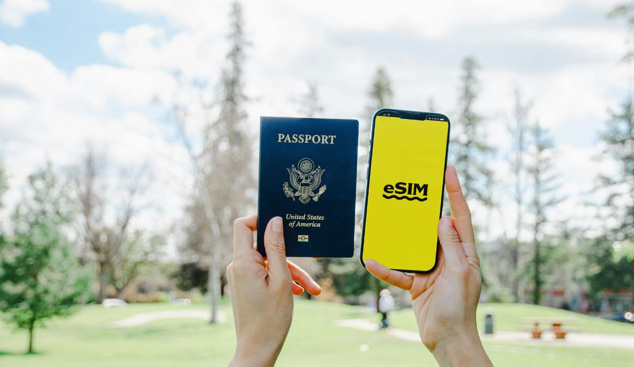 Hands inserting SIM card or adjusting roaming settings on mobile phone.