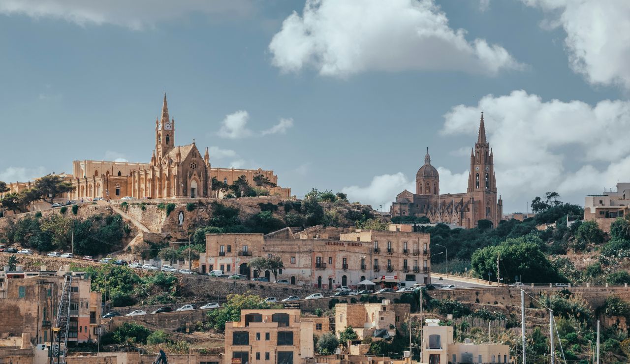 Historic hilltop churches and stone buildings in Gozo, Malta.