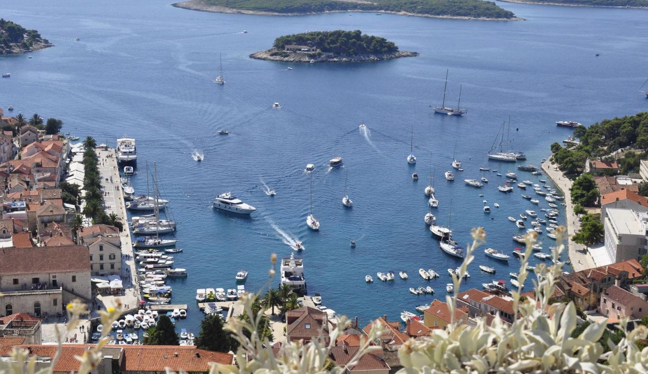 Scenic harbor filled with boats and yachts in Hvar, Croatia.