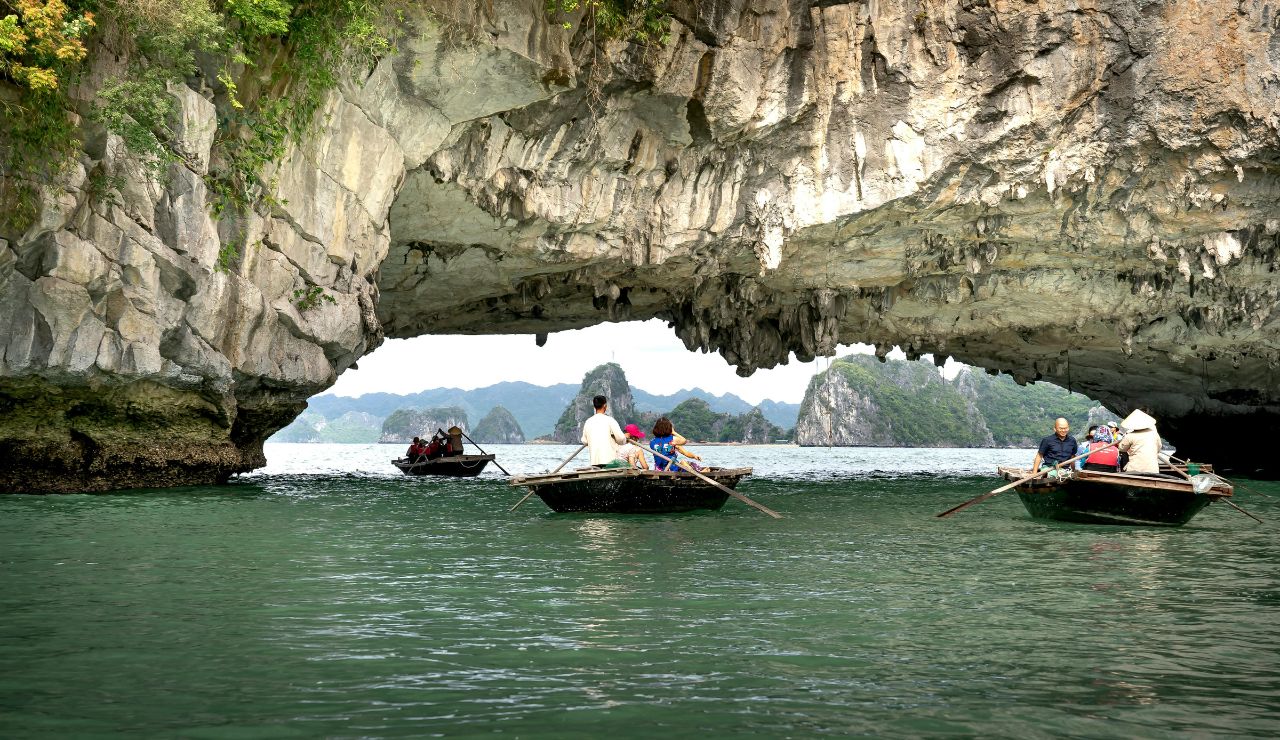 Tourists kayaking in a sea cave in Phang Nga Bay