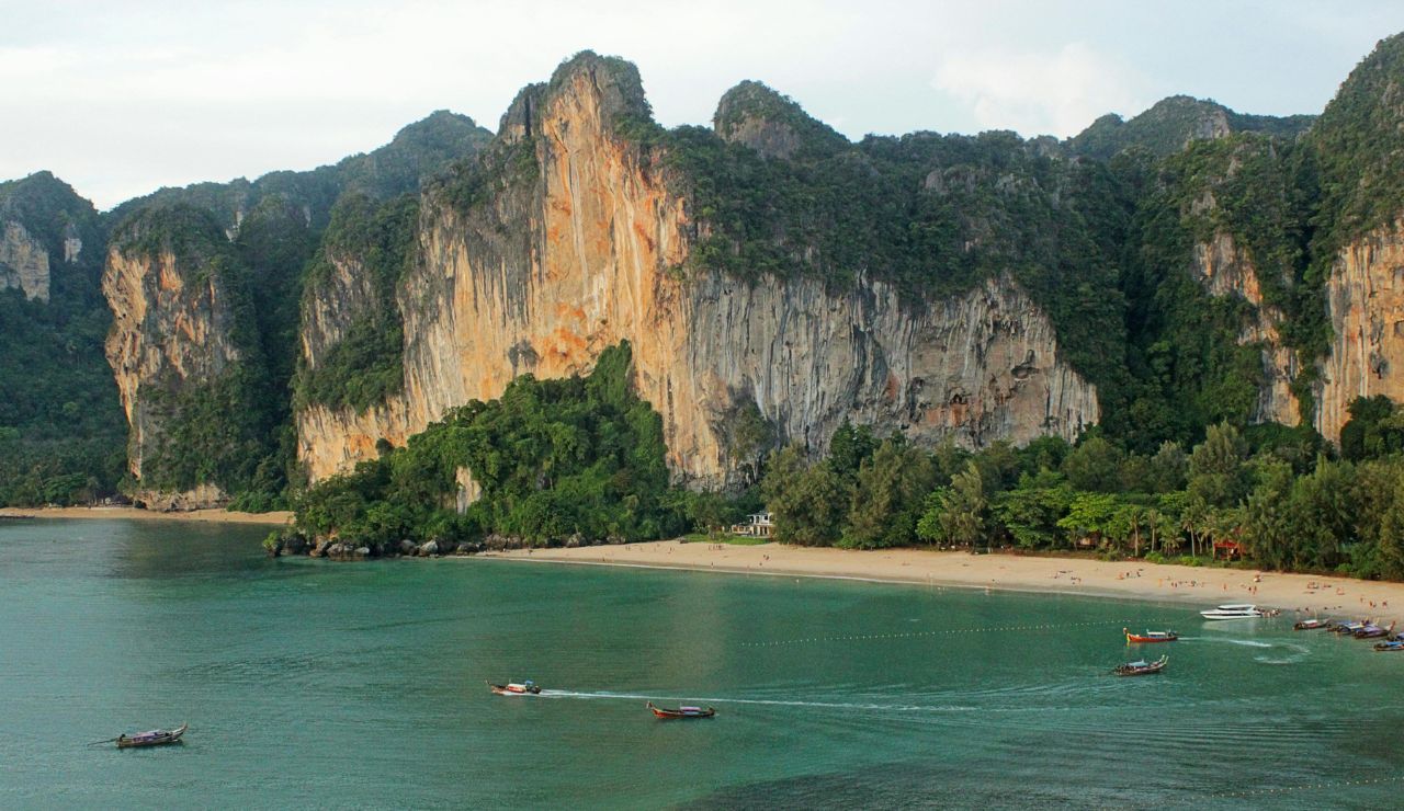 Rock climber scaling limestone cliffs at Railay Beach