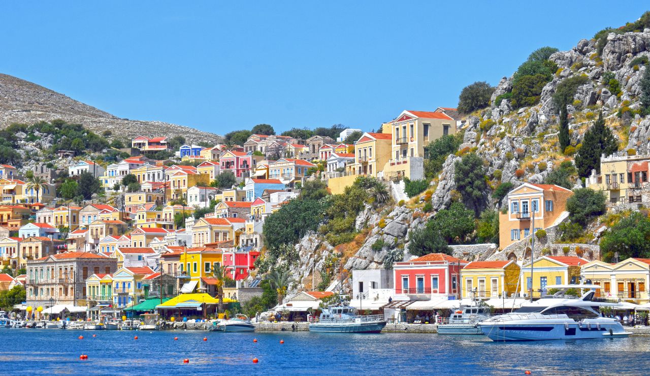 Colorful hillside houses and waterfront in Symi, Greece.