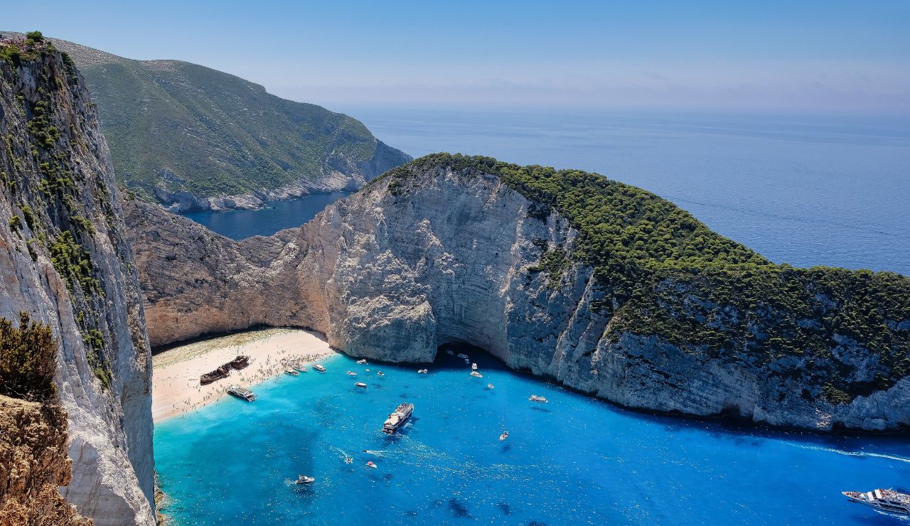 Navagio Beach in Zakynthos, Greece, with turquoise waters and a shipwreck on the shore.