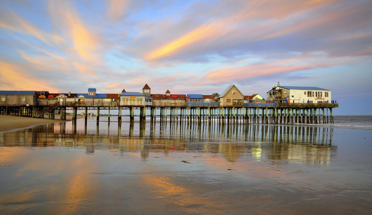 Pier at Old Orchard Beach with people enjoying the sand and ocean

