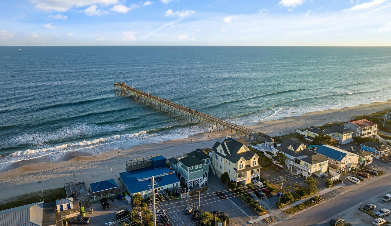 ootprints in sand leading to ocean near St. Augustine Beach pier
