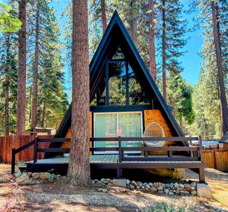 An A-Frame Cabin in Kings Beach among alpine trees.