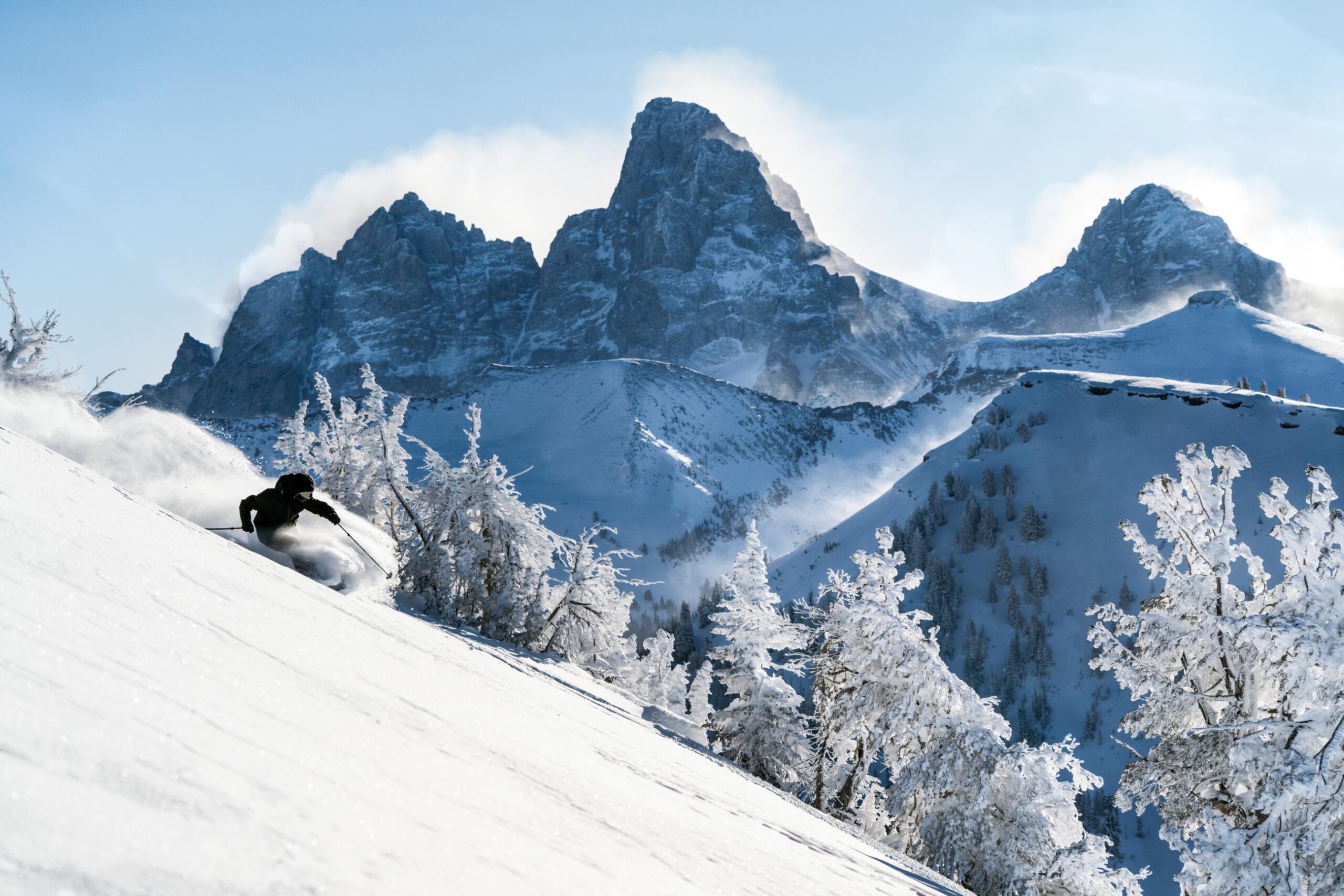 A skier races down a snowy slope at Grand Targhee Ski Resort, one of the most romantic ski resorts in the USA.