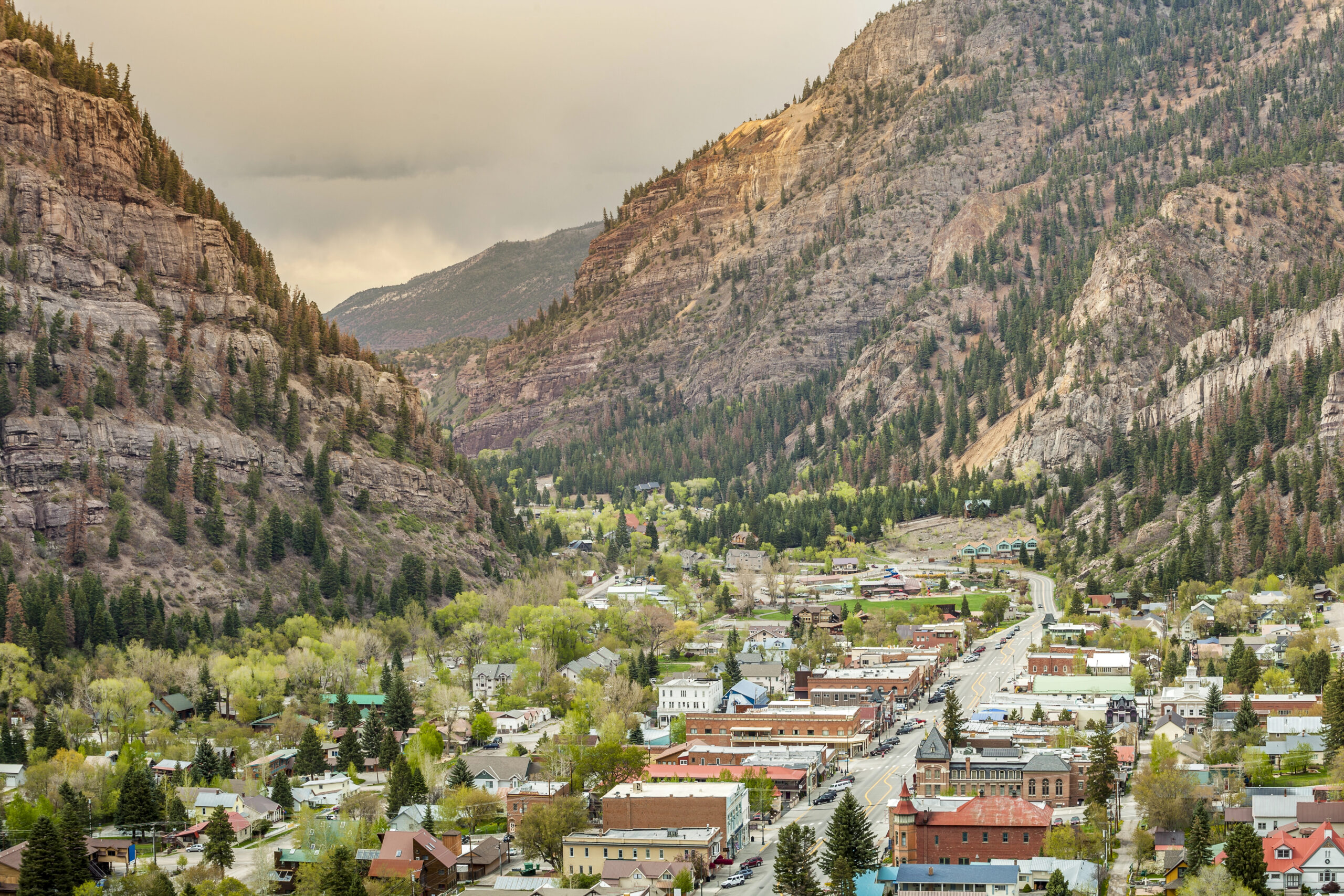 Town of Ouray located between towering mountains, one of the best romantic mountain getaways in Colorado.