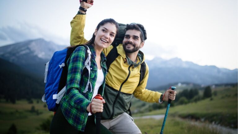 An image of a couple hiking and smiling.