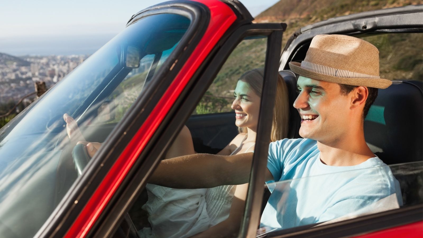 A couple enjoying their car ride.