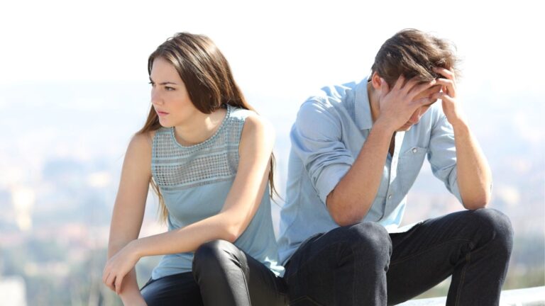 An image of a couple sitting and stressed out.