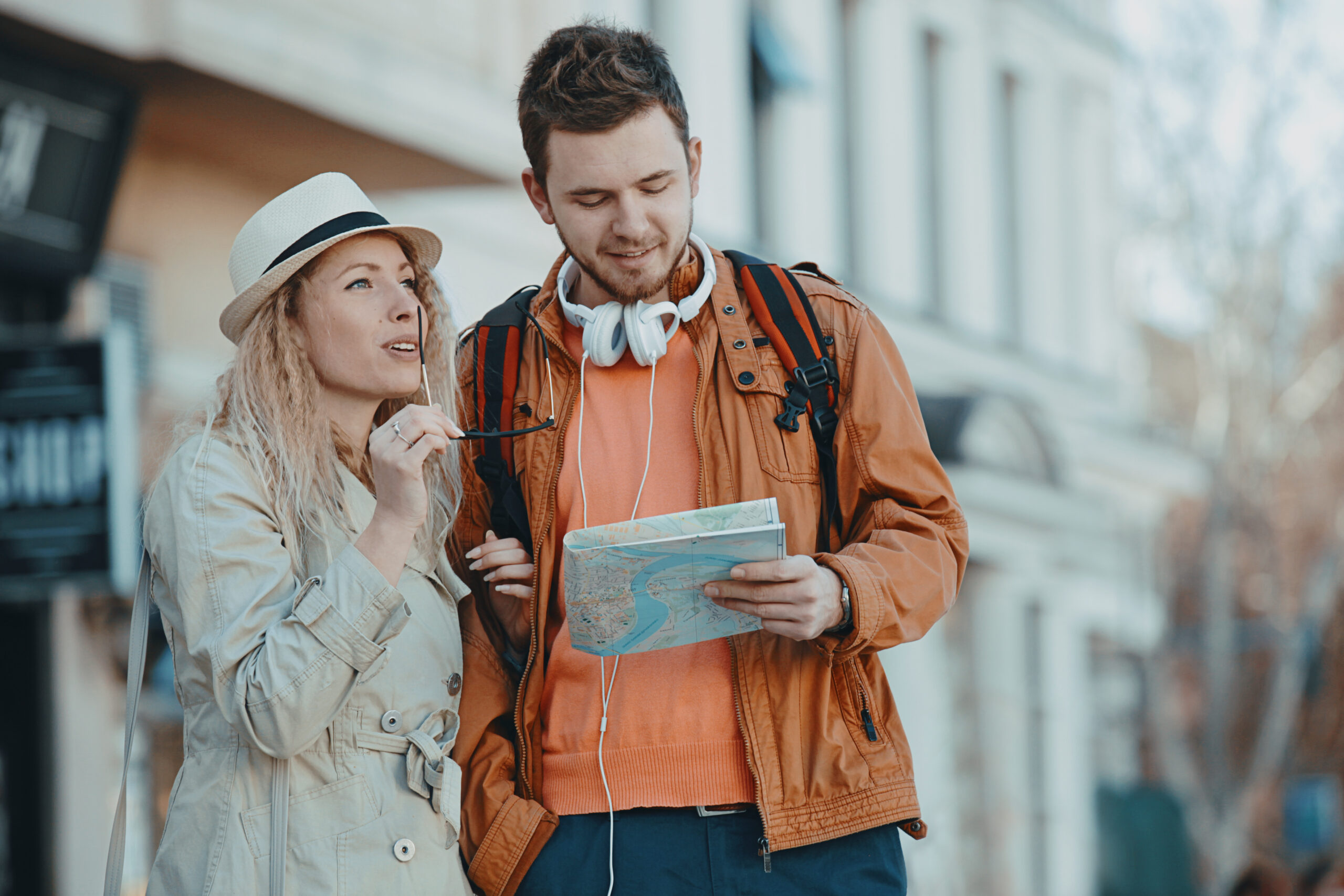 Couple tourist walking in downtown and looking at city map.