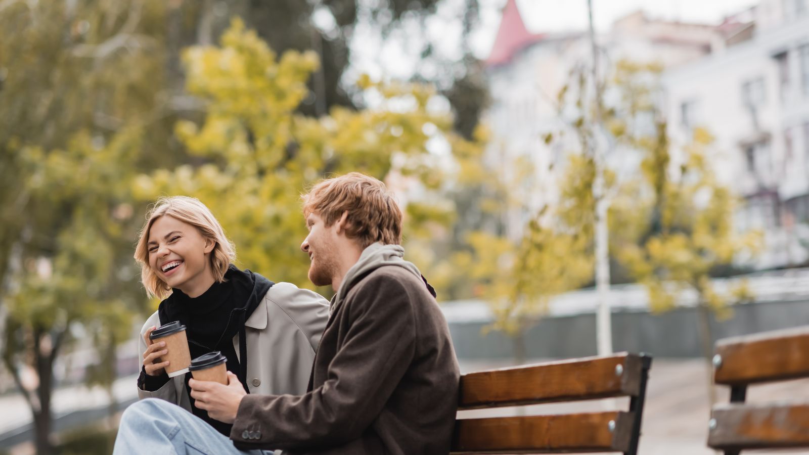 A photo of a relaxed couple in a nearby park or café, laughing.