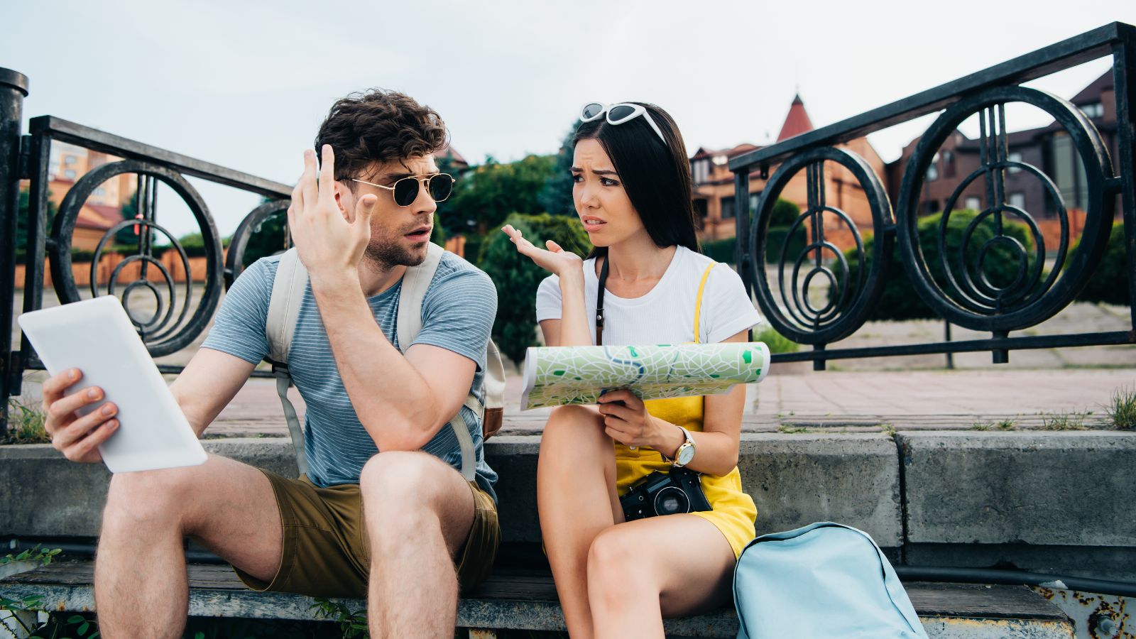 A picture of two travelers looking stress while the girl is holding a map