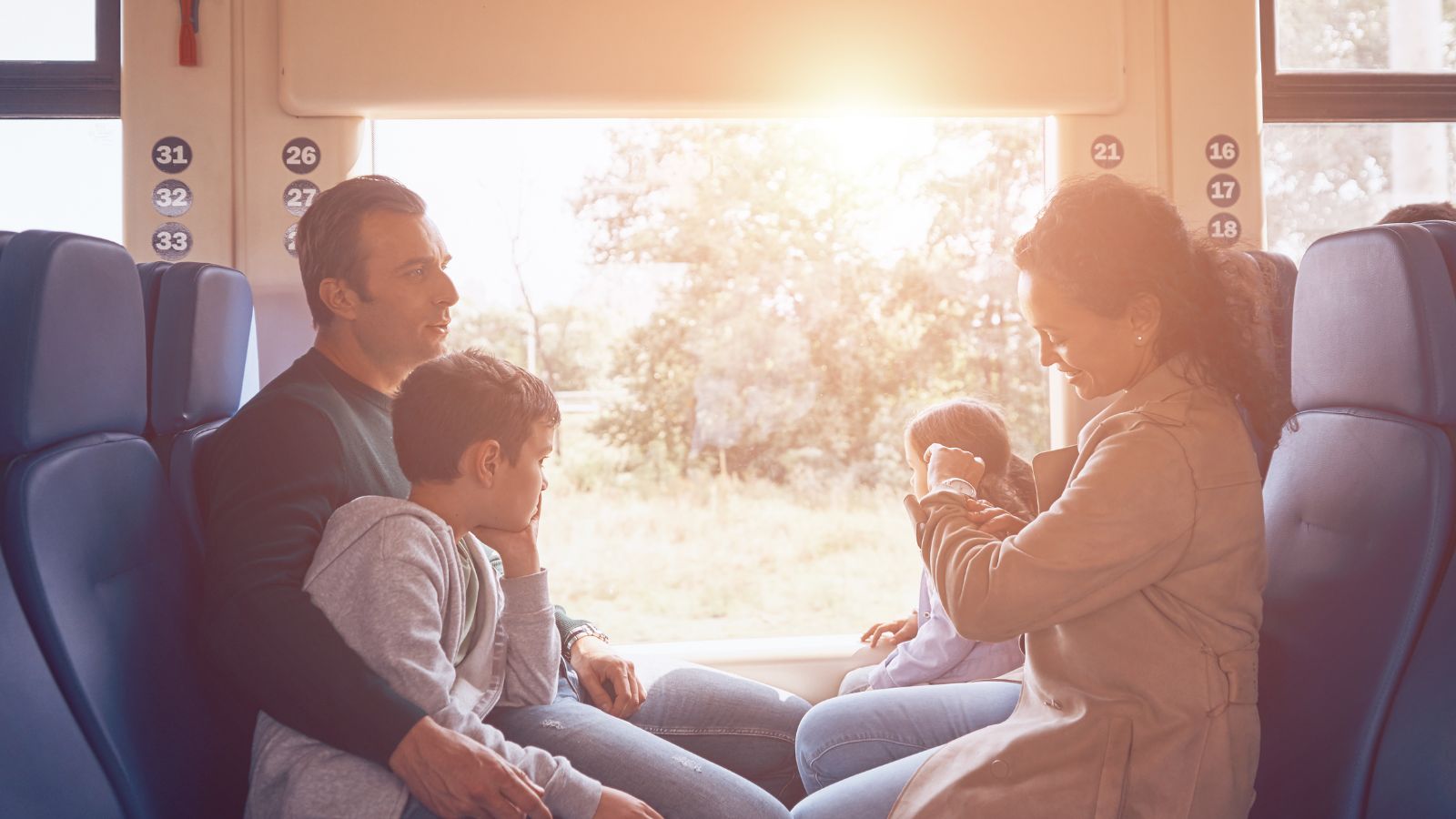 A photo of Family sitting together during travel downtime, road trip.