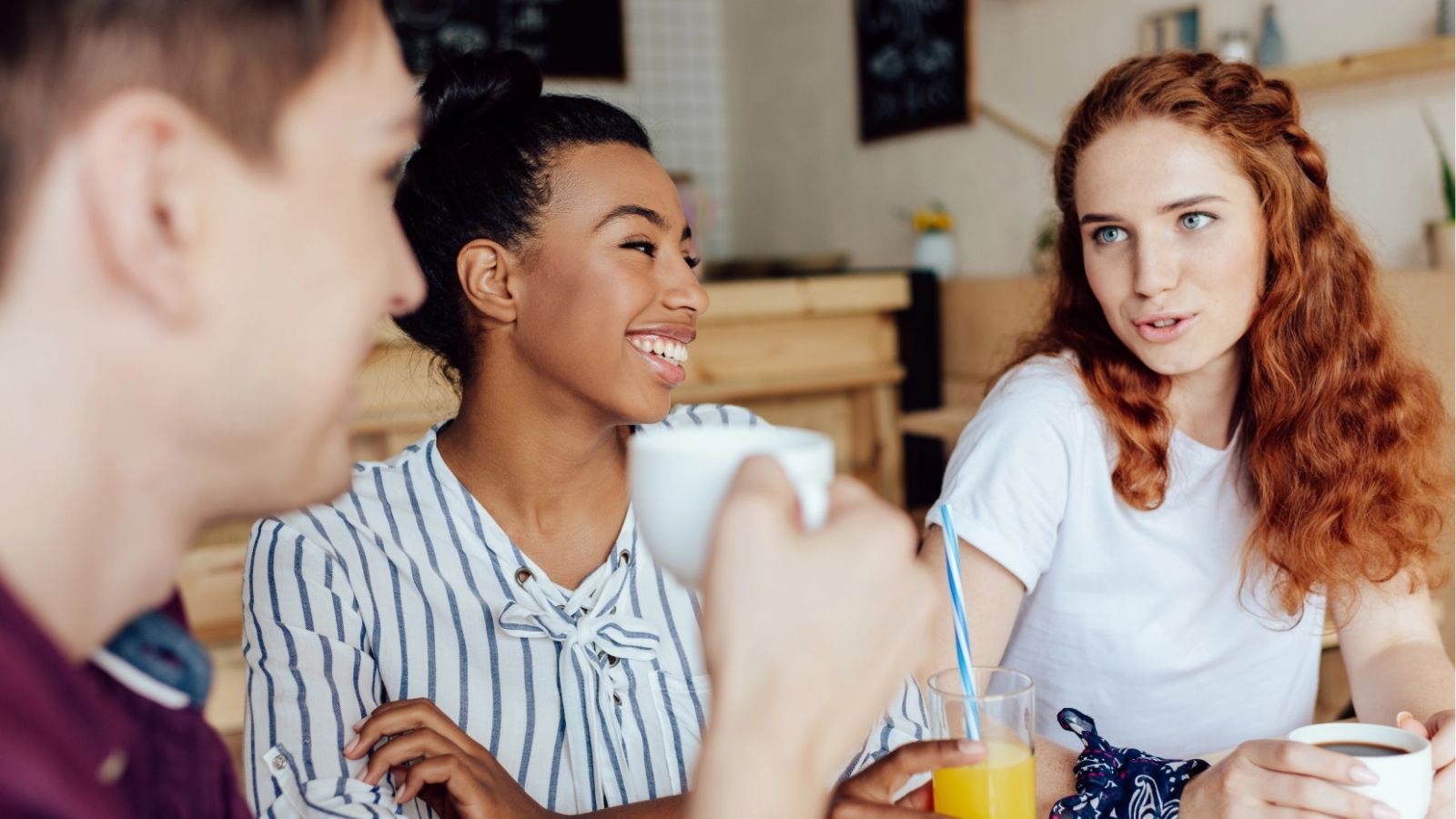 An image of three friends talking.