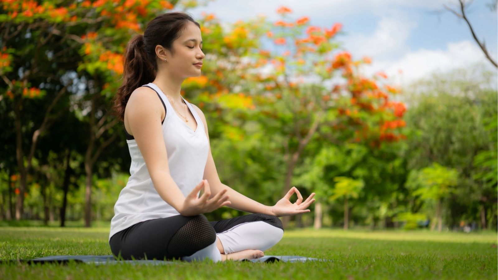 An image of a girl meditating outside.