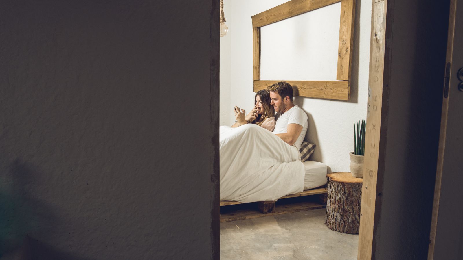  A picture of a couple on bed being so close to each other.