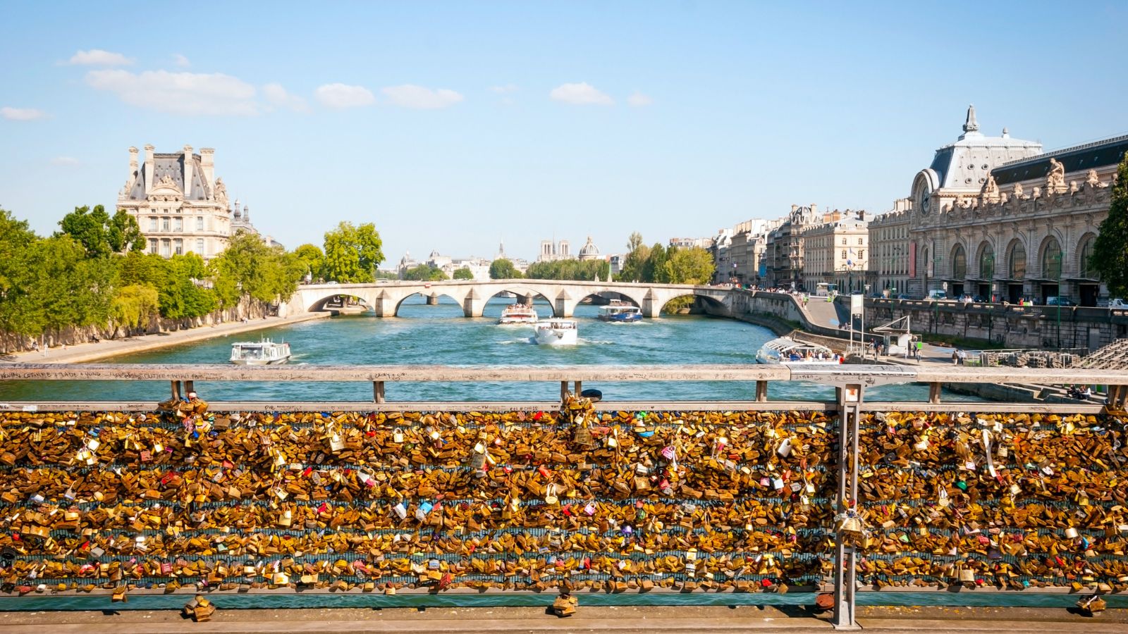 A photo of Paris bridge railing full of rusty love locks.