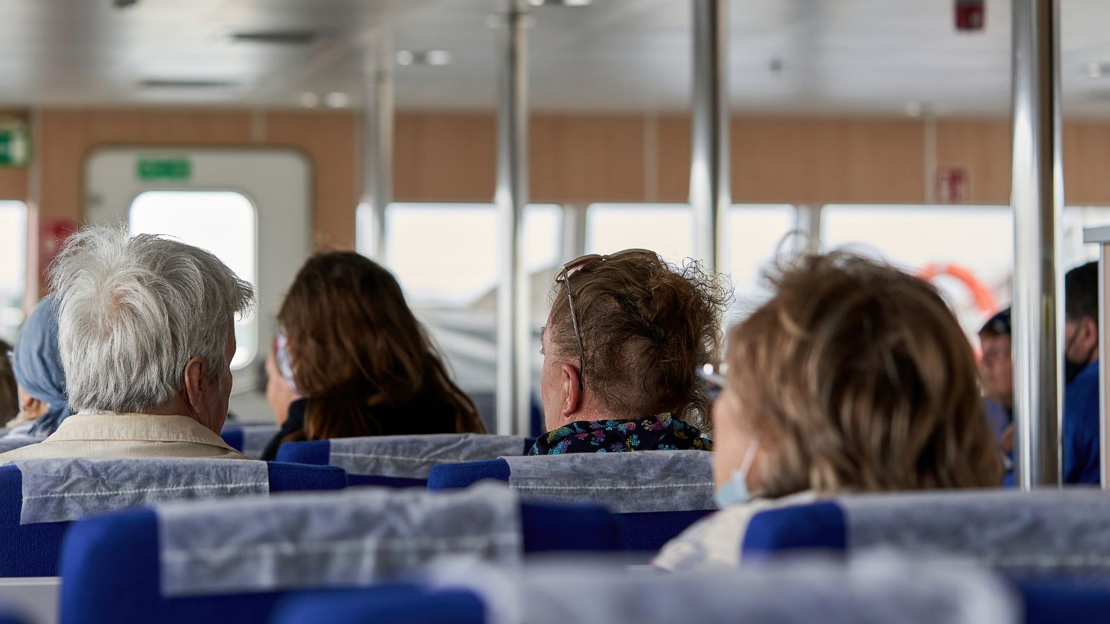 A back photo of passengers seating calmly.