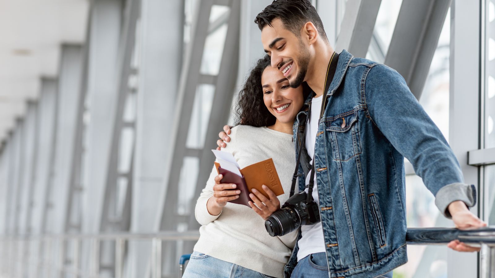 Lovebirds happily looking at a passport.