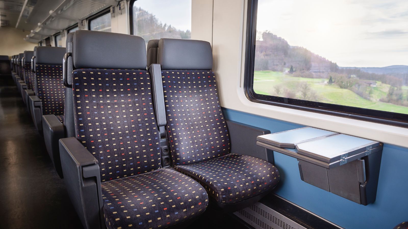 A photo of an Interior of a Swiss train carriage.