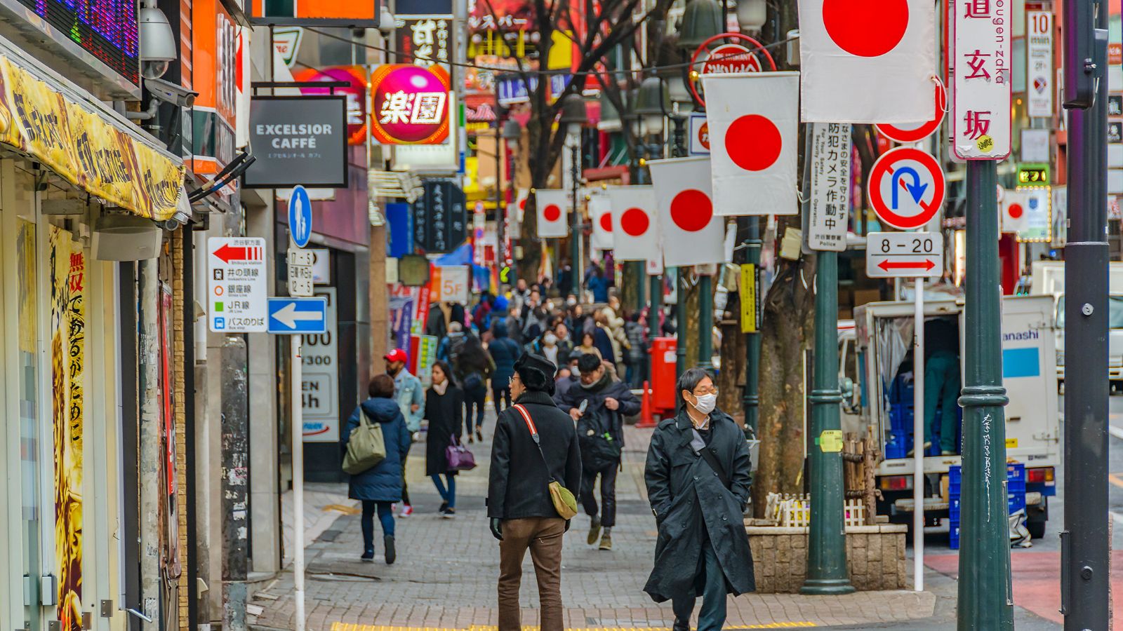 A photo of Tokyo or Kyoto city street scene with locals walking calmly and orderly; clean streets.