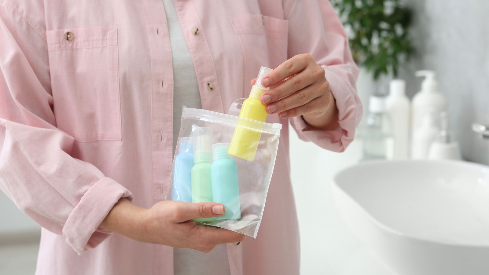 Travel-size shampoo, conditioner, and lotion neatly arranged in a hotel bathroom, ready for use, soft lighting, minimalistic style.