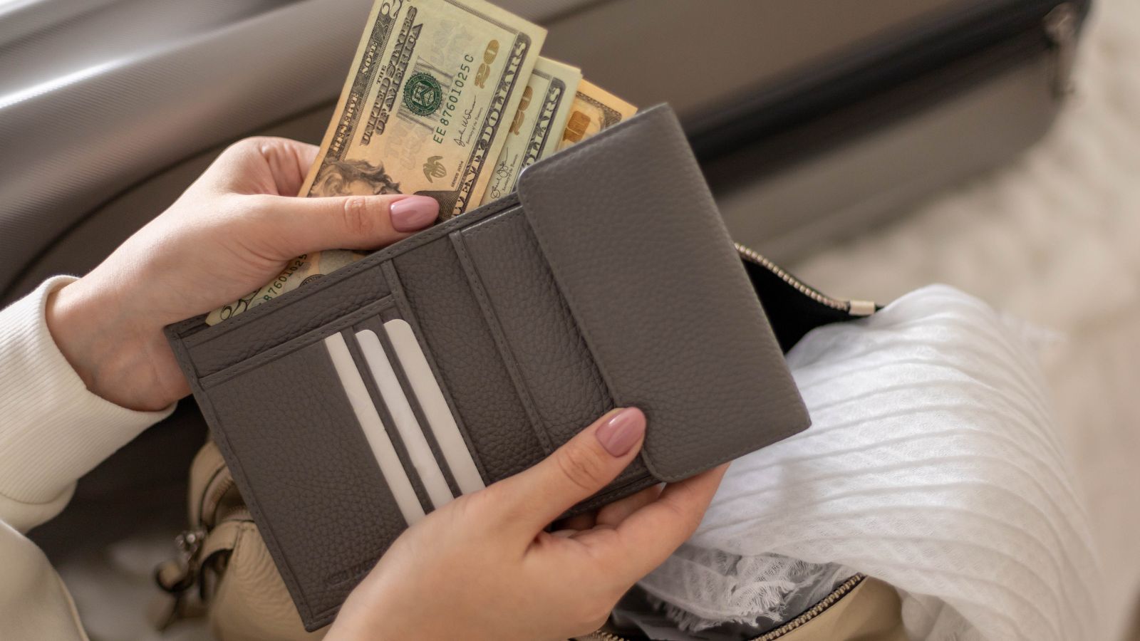 A photo of Overstuffed wallet with visible cash, travel setting, subtle risk concept.