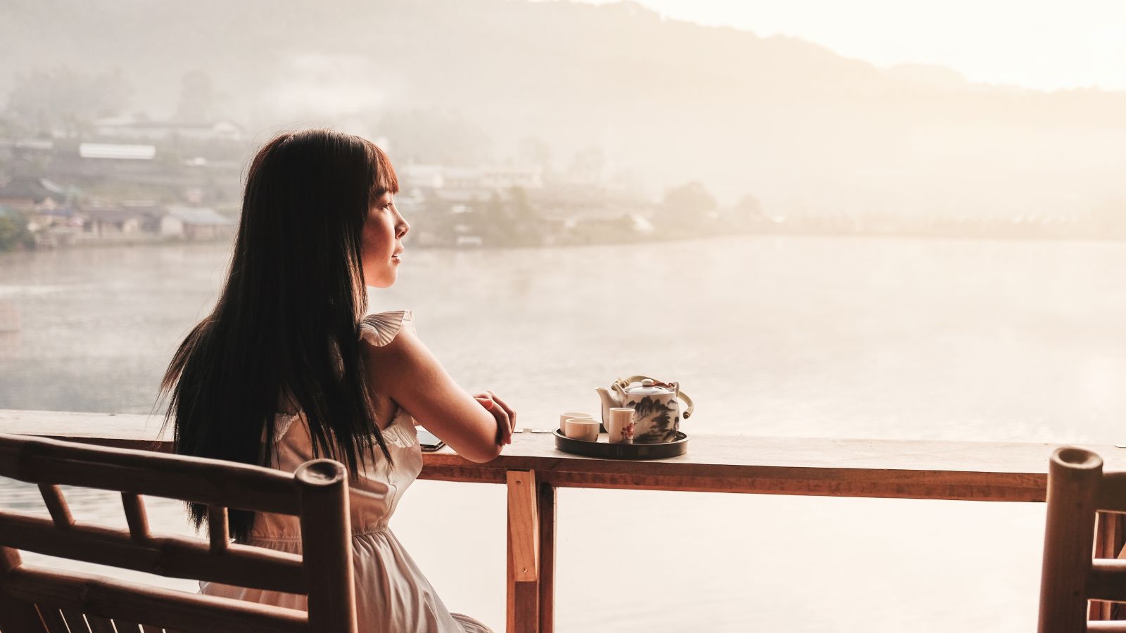 A photo of a traveler enjoying the surroundings; relaxed but mindful mood, warm lighting, emphasis on being present.