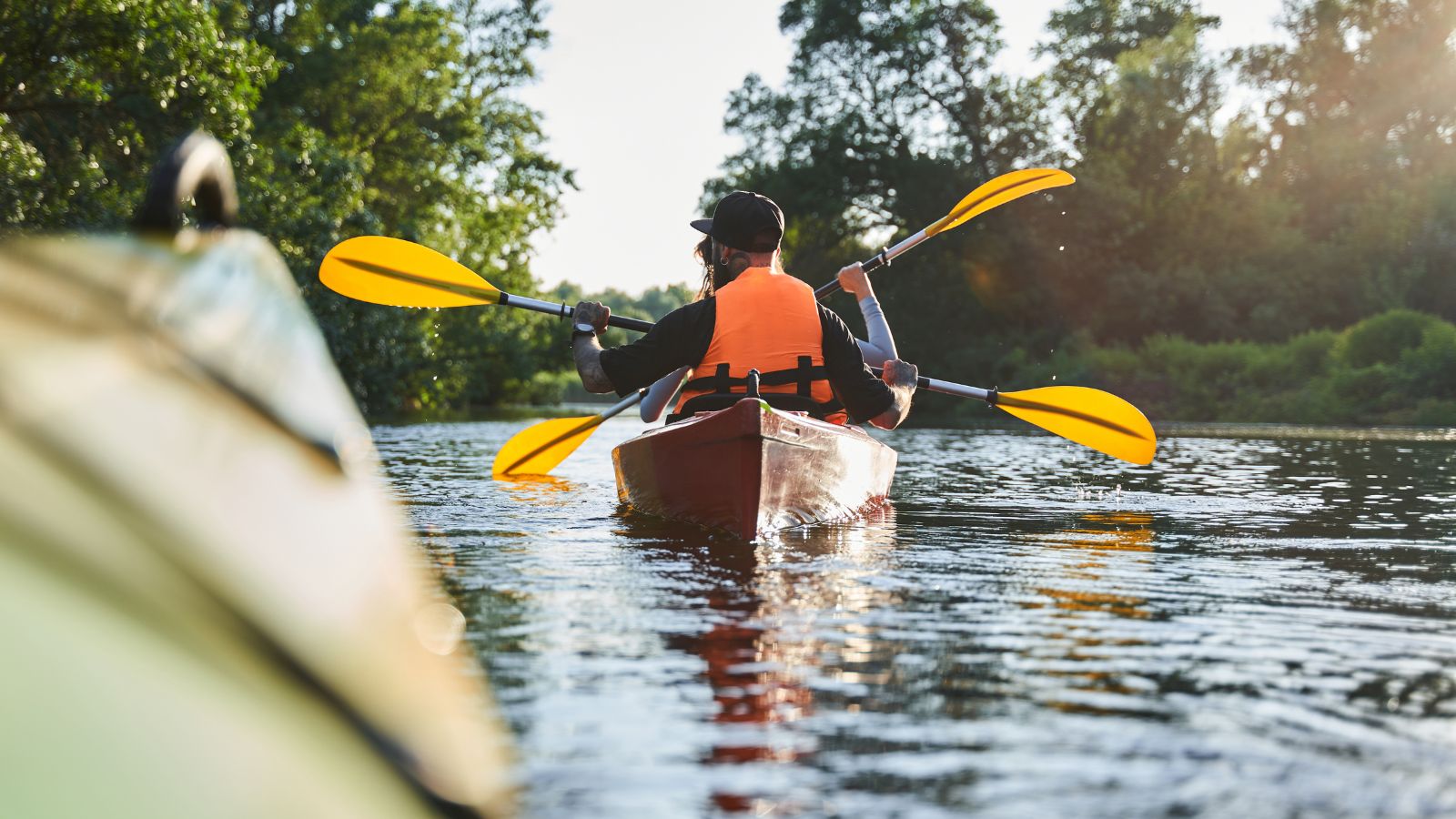 A photo of two couple paddling in a different way.