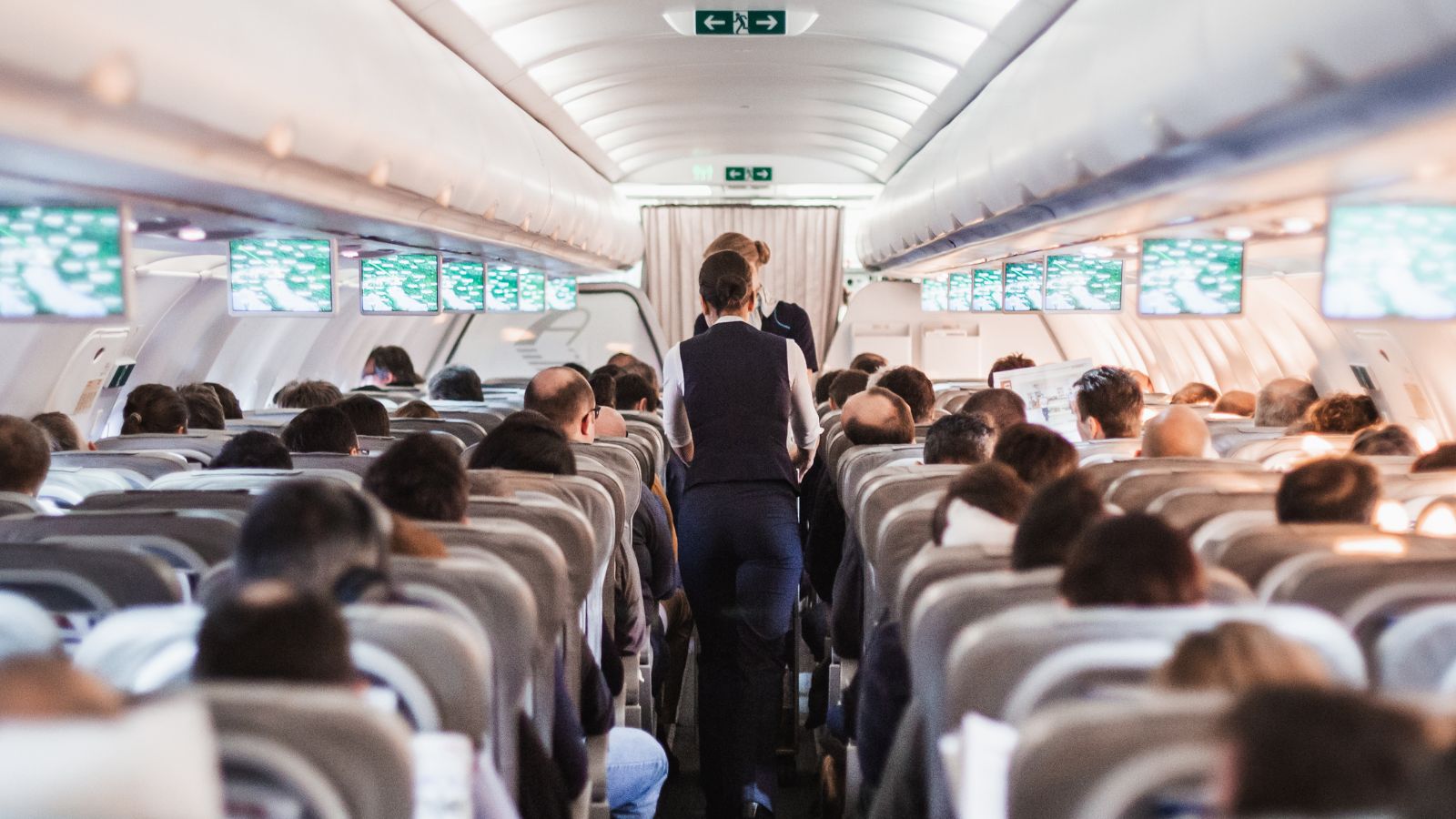 A photo of a full airplane cabin economy class passengers.