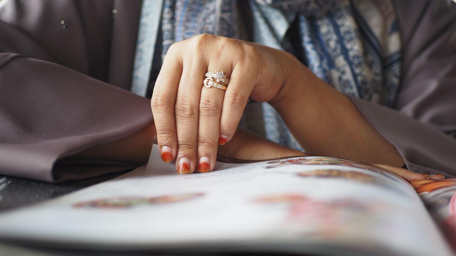 A photo of a Visitor reading official UAE tourism guide.