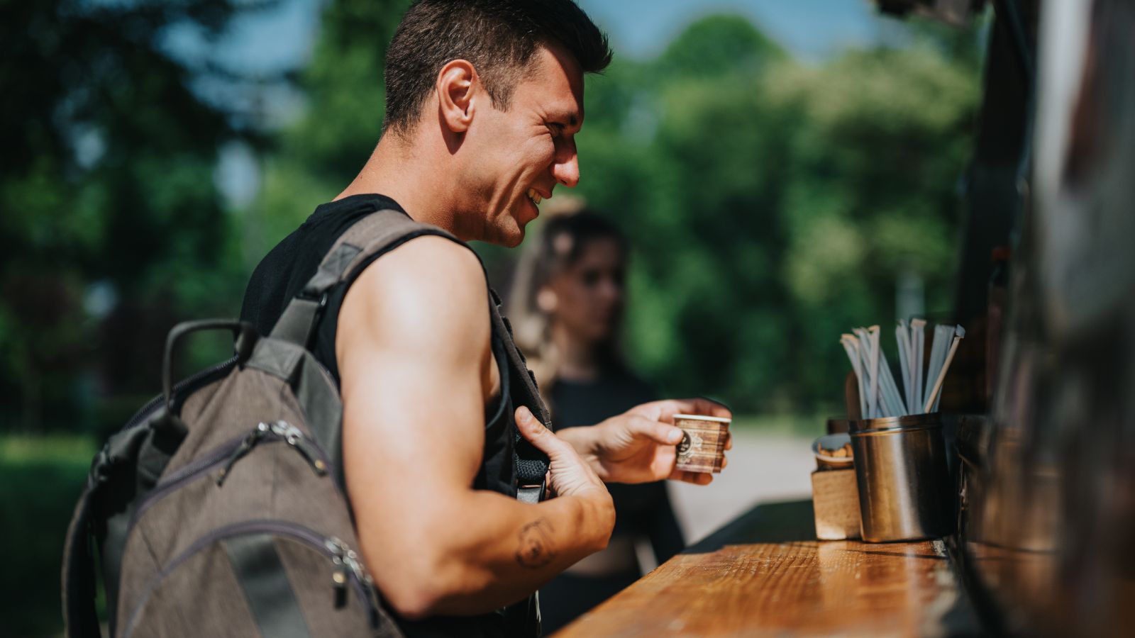 A photo of a Traveler happily eating local food outdoors.