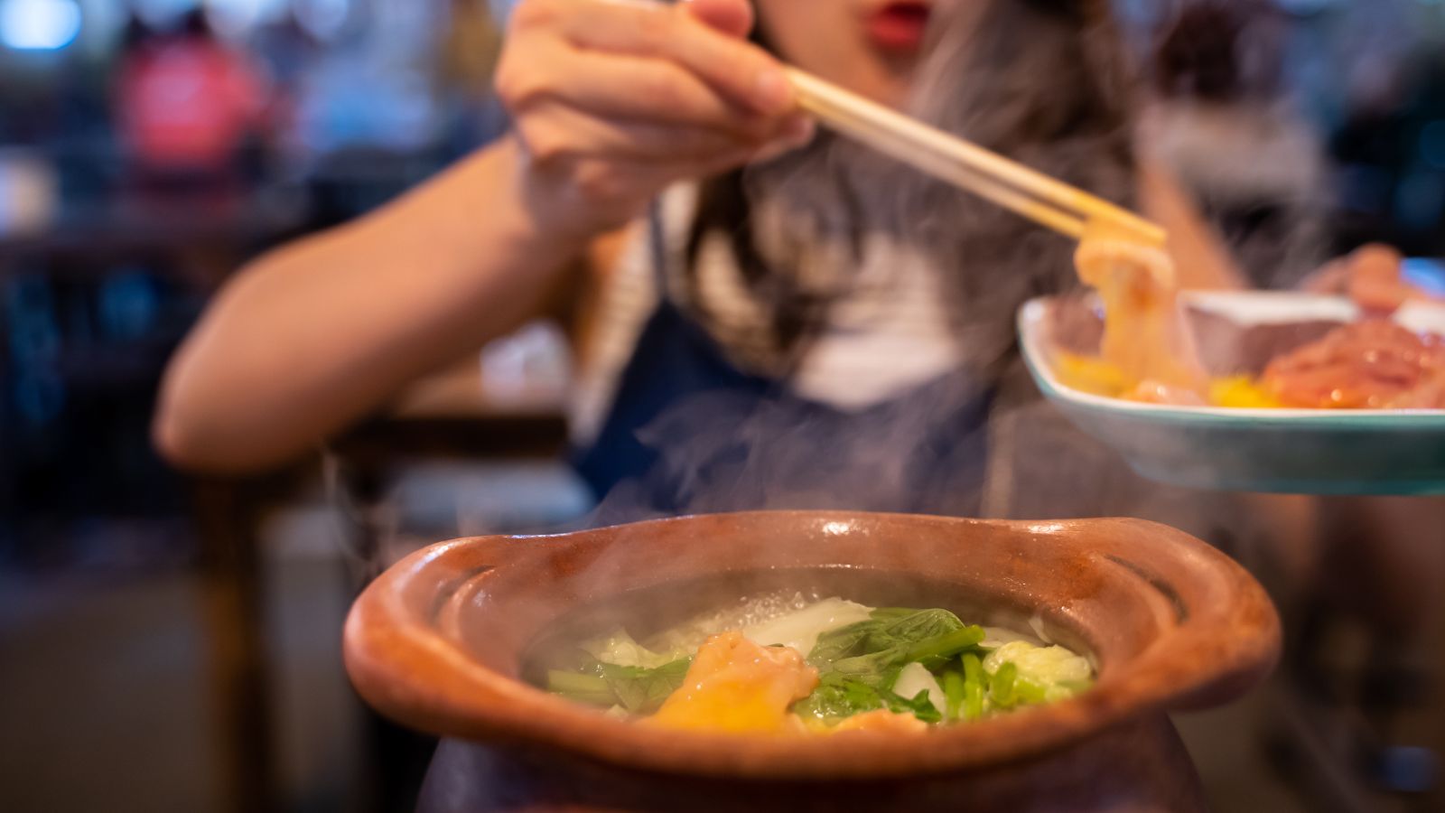 A photo of a surprised expression, steam rising from dish, vibrant local cuisine.