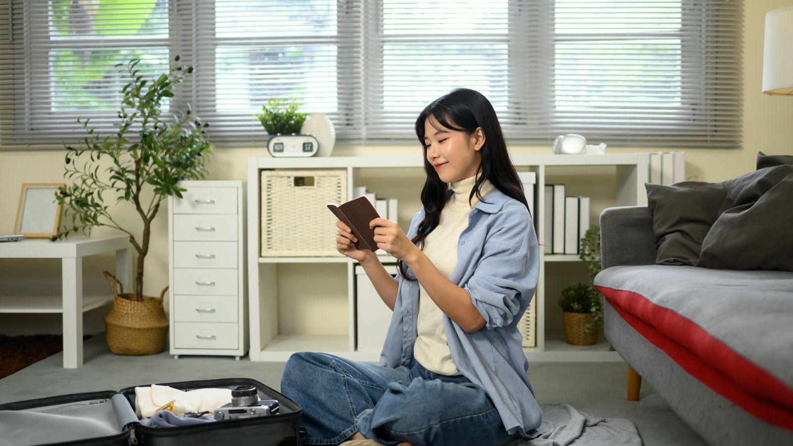 A photo of a Traveler calmly reviewing passport at home before a trip.